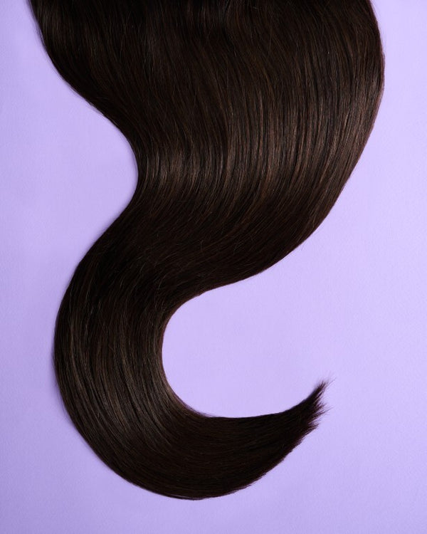 Close-up of medium brown hair extensions offering a rich, balanced brown shade with subtle depth