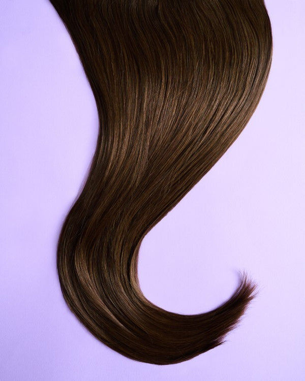 Detail view of brown hair extensions with deep, rich brown tones for a natural, full-bodied look