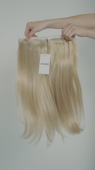 Video of strawberry blonde hair extensions with soft, warm red undertones and natural shine